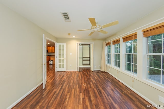 spare room with ceiling fan and dark wood-type flooring