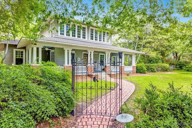 1311 Woodward Ave, Montgomery, AL 36106 - view of front facade featuring covered porch, a front lawn, and a gate