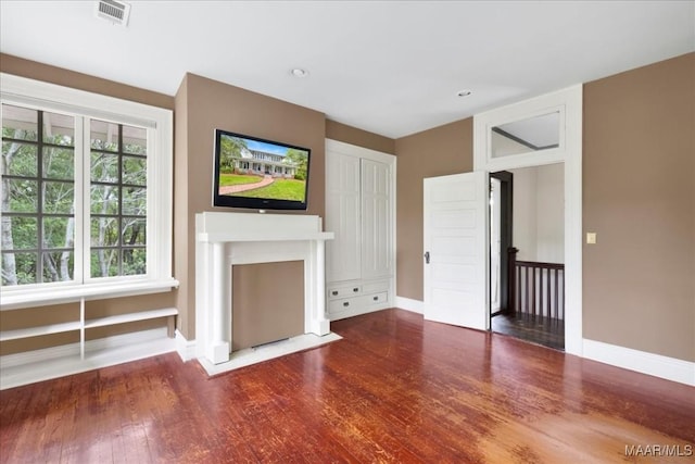 1311 Woodward Ave, Montgomery, AL 36106 - unfurnished living room with baseboards and wood finished floors