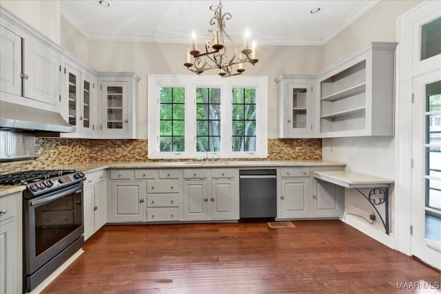 1311 Woodward Ave, Montgomery, AL 36106 - kitchen with appliances with stainless steel finishes, a chandelier, under cabinet range hood, glass insert cabinets, and crown molding