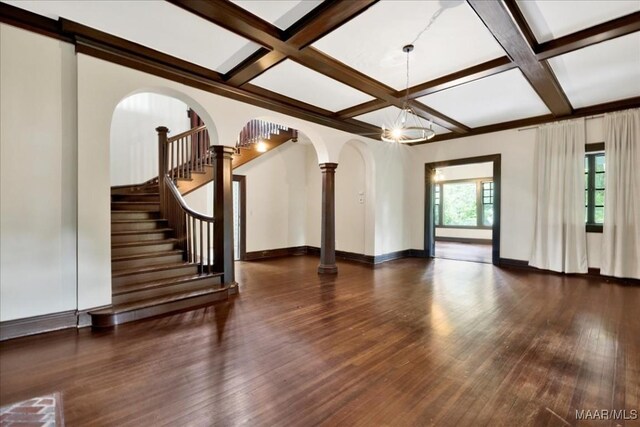 1311 Woodward Ave, Montgomery, AL 36106 - unfurnished living room featuring coffered ceiling, wood finished floors, beamed ceiling, baseboards, and ornate columns