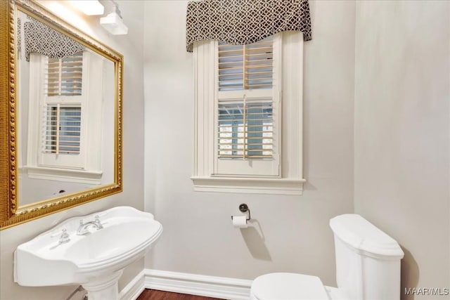 1311 Woodward Ave, Montgomery, AL 36106 - bathroom with toilet, plenty of natural light, a sink, and baseboards