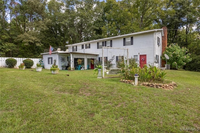 back of house with a yard and a deck