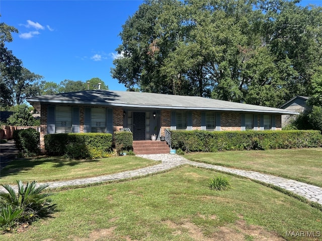 ranch-style home featuring a front yard