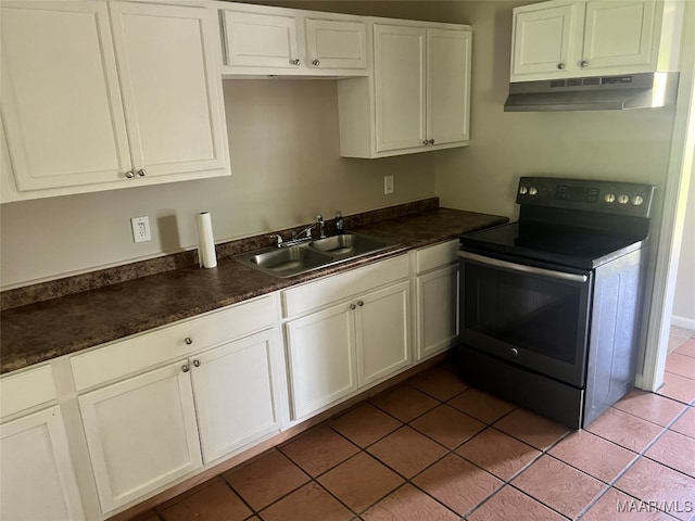 kitchen featuring sink, tile patterned flooring, electric range, and white cabinetry