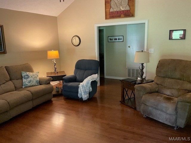 living room featuring dark hardwood / wood-style flooring and high vaulted ceiling