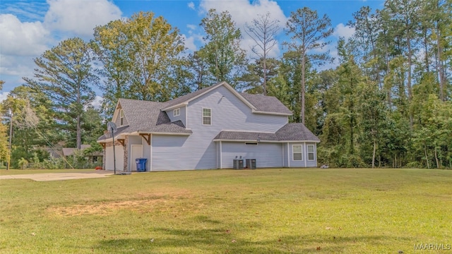 view of front of property featuring central AC unit, a front yard, and a garage