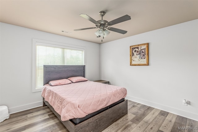 bedroom featuring ceiling fan and hardwood / wood-style flooring