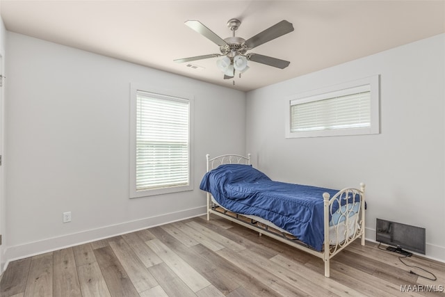 bedroom featuring light hardwood / wood-style floors and ceiling fan