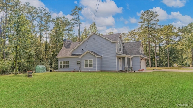 back of house with a lawn