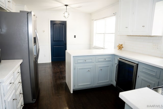 kitchen featuring pendant lighting, tasteful backsplash, white cabinetry, stainless steel refrigerator, and dark hardwood / wood-style flooring