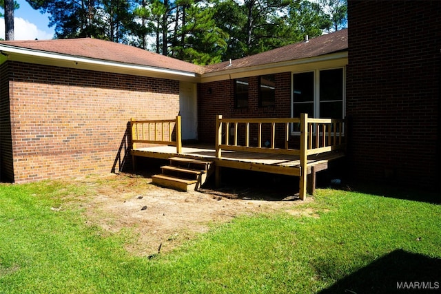 wooden deck featuring a lawn