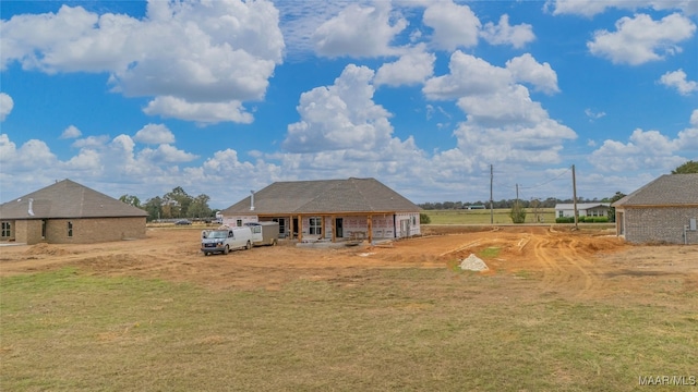 back of property featuring a lawn