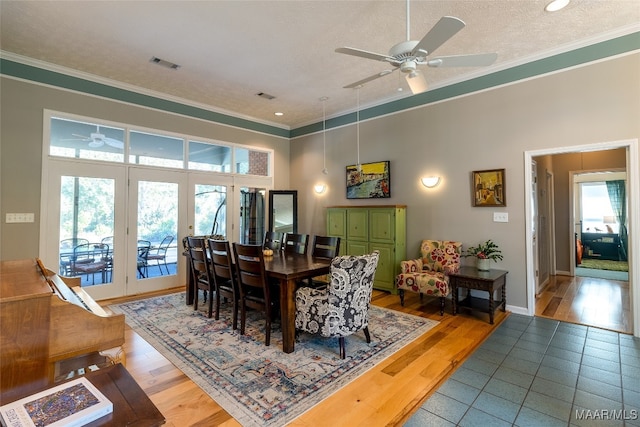 dining room with ceiling fan, french doors, a textured ceiling, hardwood / wood-style flooring, and crown molding