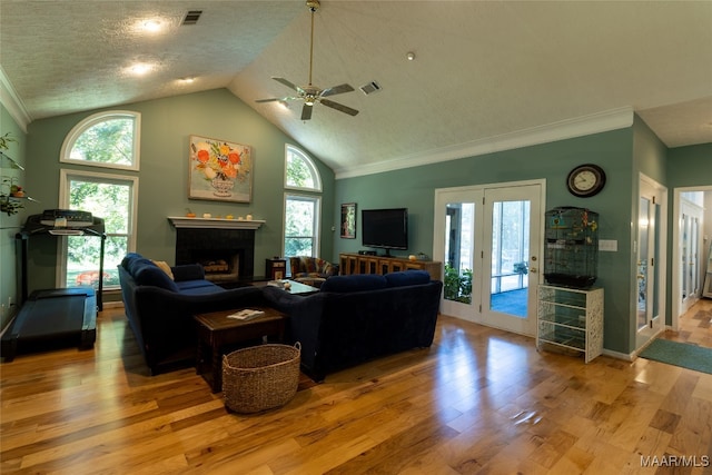 living room featuring crown molding, high vaulted ceiling, light hardwood / wood-style flooring, and ceiling fan