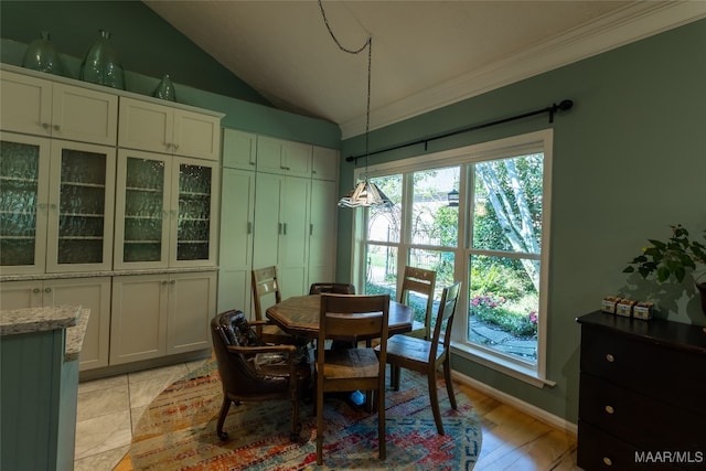 dining space featuring ornamental molding, vaulted ceiling, and light hardwood / wood-style floors