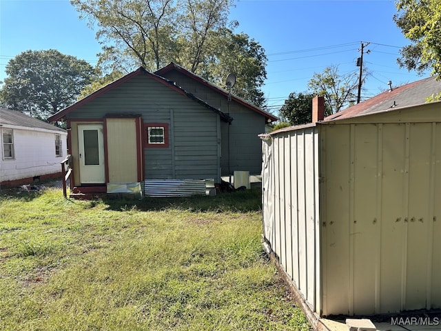 view of outbuilding with a lawn