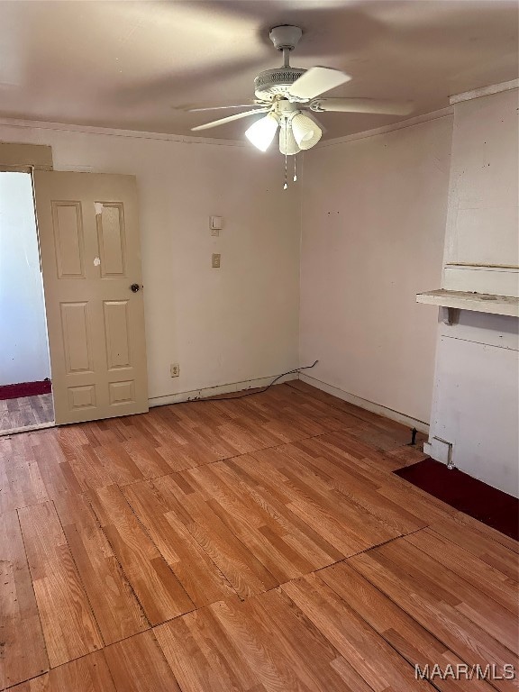 spare room featuring light wood-type flooring and ceiling fan