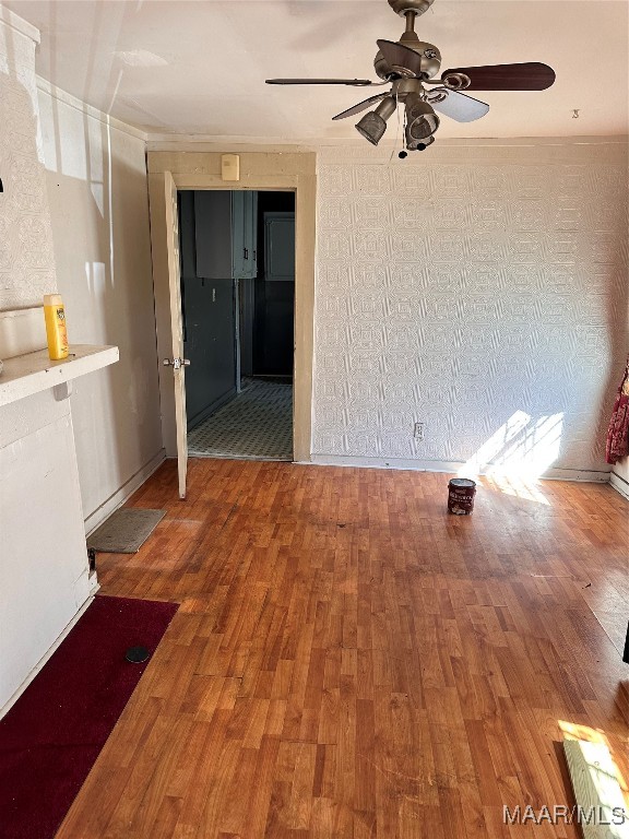 empty room with wood-type flooring and ceiling fan