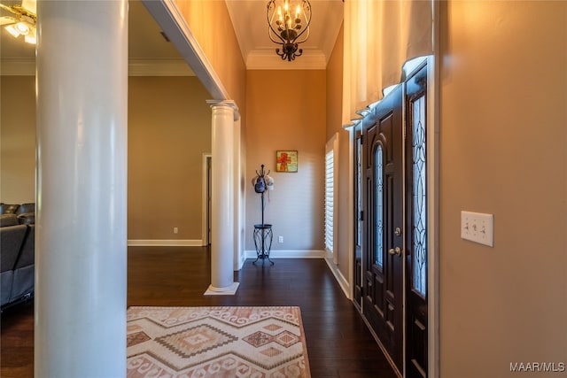 entryway with dark hardwood / wood-style floors, ornamental molding, and decorative columns