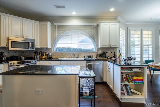 kitchen featuring white cabinets, a kitchen island, and stainless steel appliances