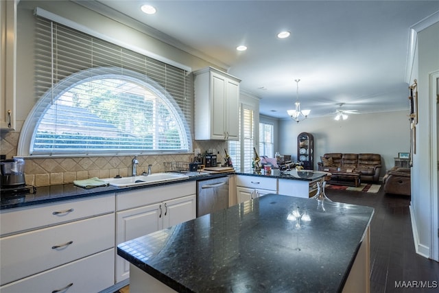 kitchen featuring backsplash, stainless steel dishwasher, a kitchen island, dark hardwood / wood-style floors, and white cabinetry