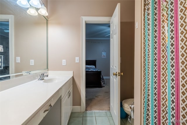 bathroom with tile patterned flooring, vanity, toilet, and ornamental molding