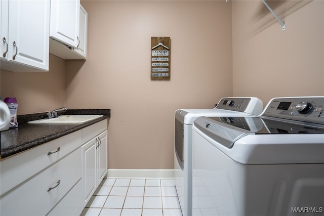 laundry room with cabinets, independent washer and dryer, sink, and light tile patterned floors