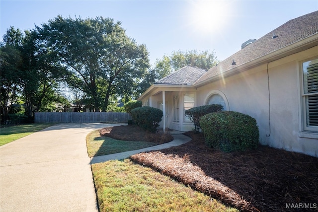 view of side of home with a lawn