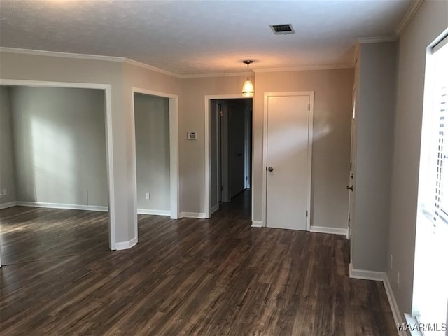 empty room with ornamental molding and dark wood-type flooring