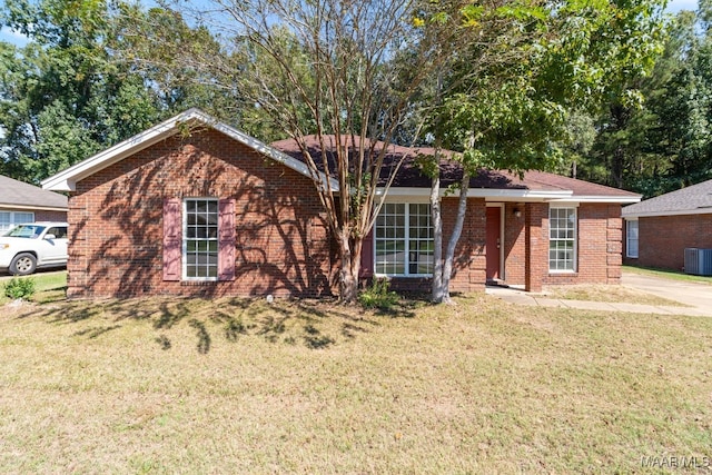 single story home featuring central air condition unit and a front lawn