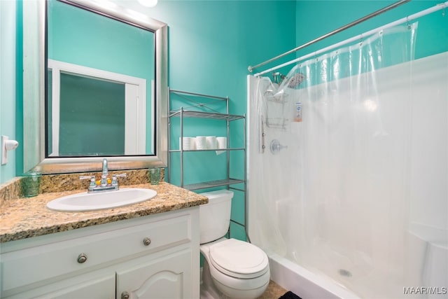 bathroom with vanity, toilet, and curtained shower