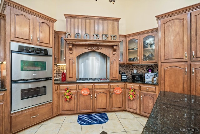 kitchen featuring light tile patterned floors, stainless steel appliances, and tasteful backsplash