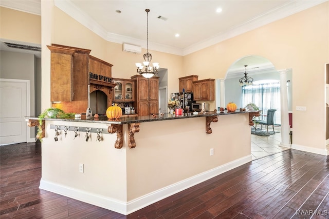 kitchen with pendant lighting, dark hardwood / wood-style floors, and crown molding