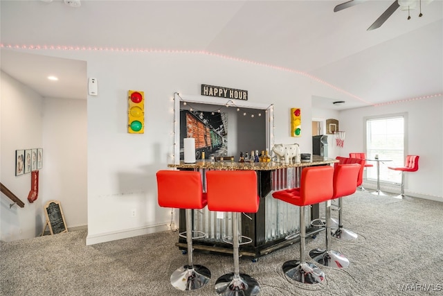 bar featuring carpet floors, vaulted ceiling, and ceiling fan