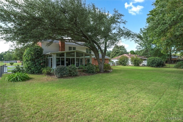 view of yard with a sunroom