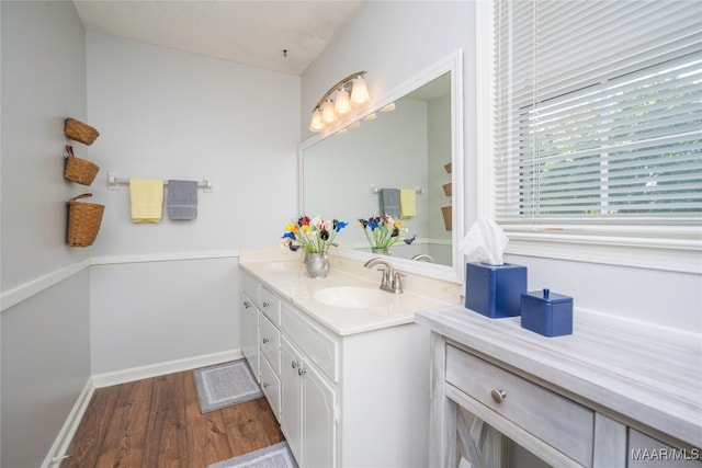 bathroom with vanity, wood-type flooring, and a textured ceiling