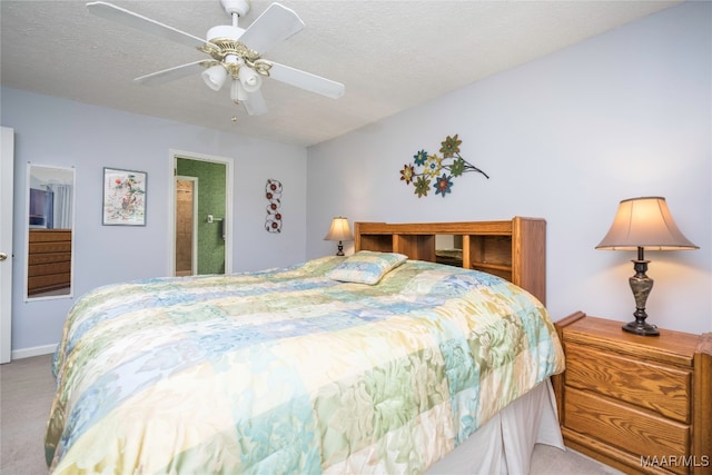 bedroom with light colored carpet, a textured ceiling, and ceiling fan