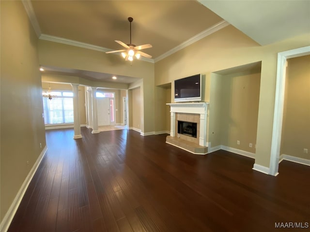 unfurnished living room with ornamental molding, ceiling fan with notable chandelier, dark hardwood / wood-style floors, and decorative columns