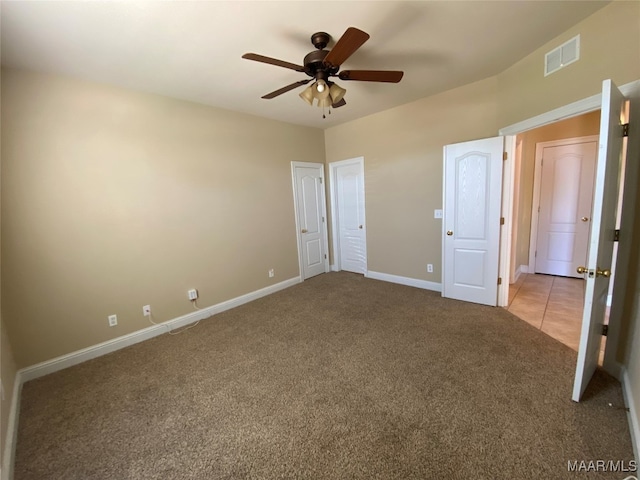 unfurnished bedroom featuring ceiling fan and light carpet