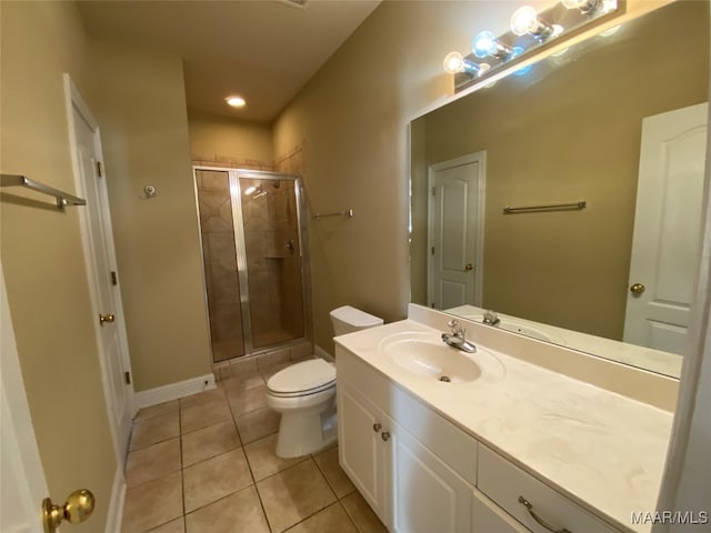 bathroom with tile patterned flooring, vanity, walk in shower, and toilet