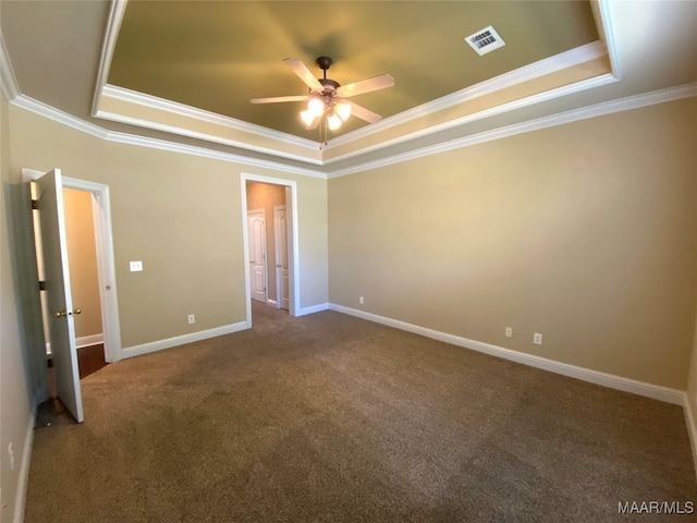 unfurnished bedroom with ceiling fan, carpet floors, a raised ceiling, and crown molding