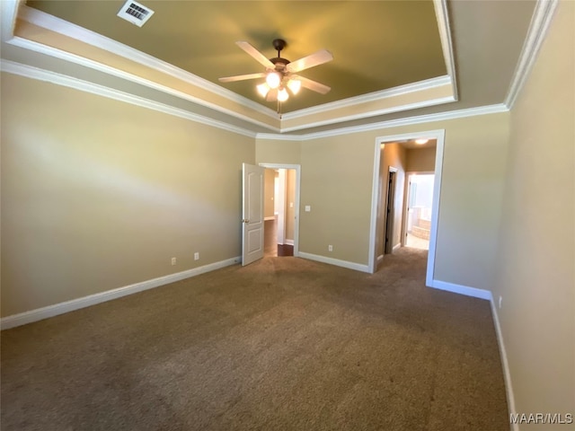 carpeted empty room featuring ornamental molding, a tray ceiling, and ceiling fan