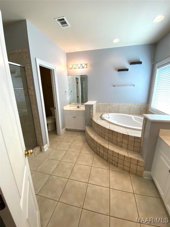 full bathroom featuring tile patterned floors, toilet, vanity, and plus walk in shower