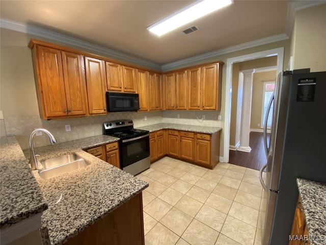 kitchen featuring light tile patterned floors, sink, stainless steel appliances, crown molding, and ornate columns