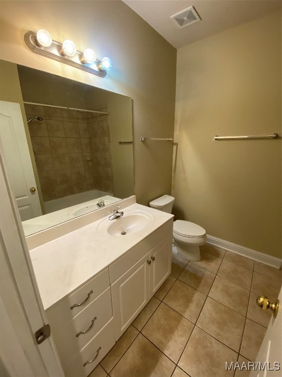 full bathroom featuring toilet, tile patterned flooring, vanity, and tiled shower / bath