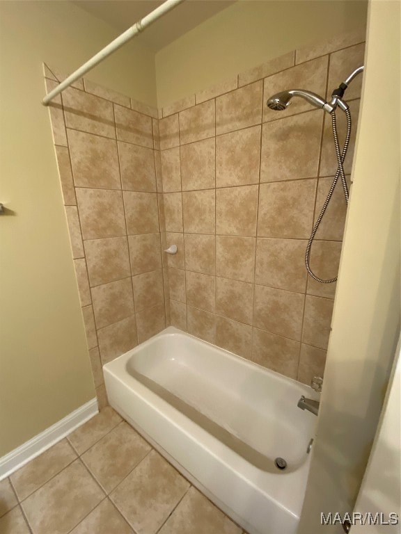 bathroom featuring tiled shower / bath combo and tile patterned flooring