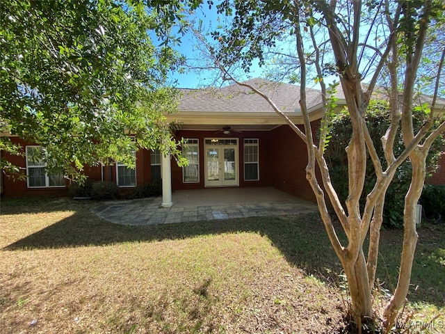 rear view of property with a yard, ceiling fan, french doors, and a patio area