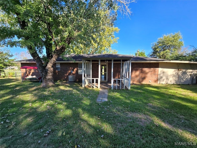 back of house with a yard and a sunroom