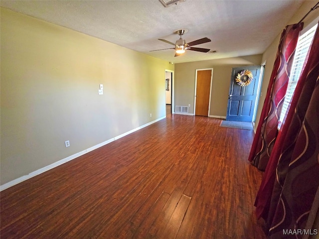 empty room with wood-type flooring, a textured ceiling, and ceiling fan